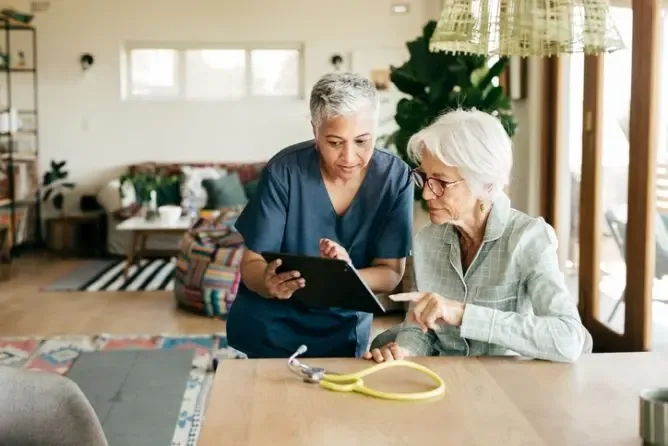 The Care Concierge Franchise owner discussing care with patient.