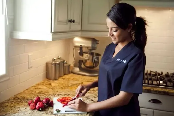 Amada Senior Care Franchise Caregiver preparing lunch